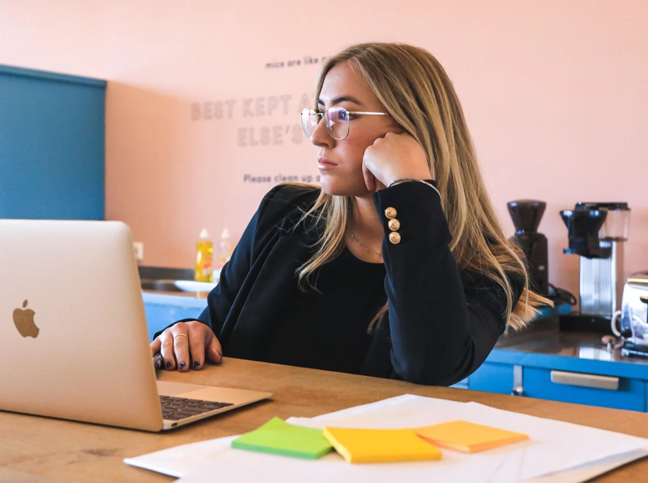 Disengaged woman staring blankly at laptop screen