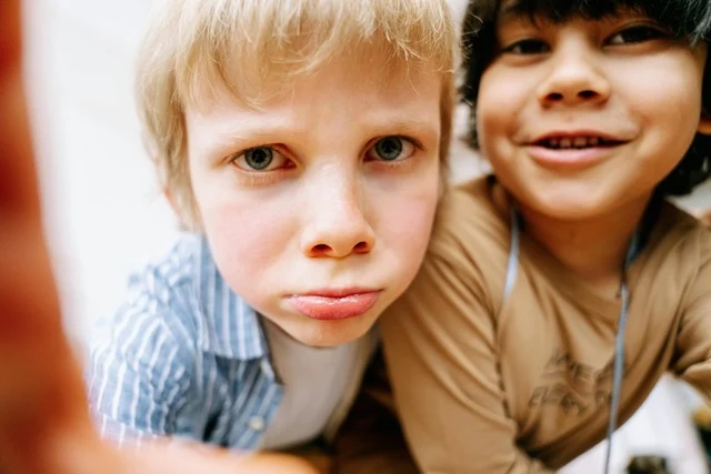 Two young boys gurning at the camera